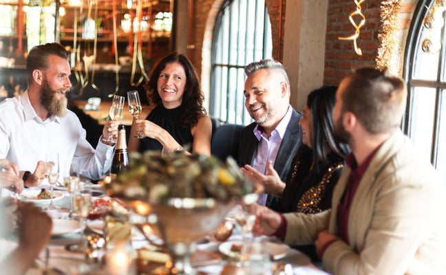Group celebrating at dinner table